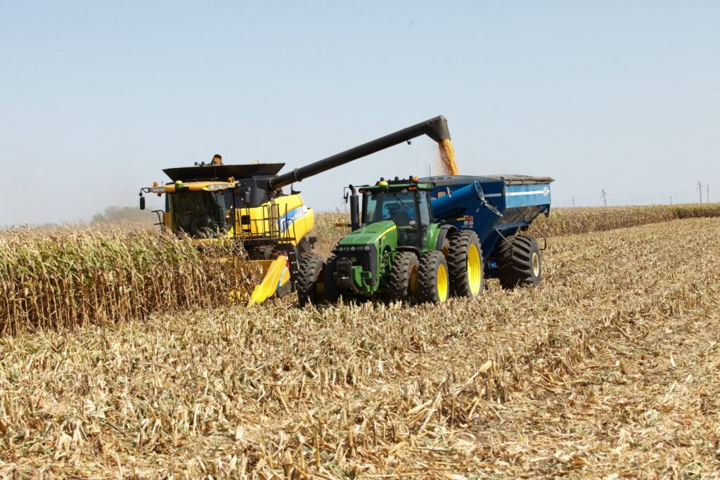 Corn-Combine-pouring-corn-into-tractor-bin-for-harvesting