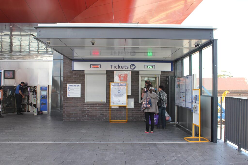 Train-Station-Ticket-Booth-With-People-Lining-Up-For-Tickets