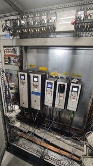 Dusty electrical control panel with debris buildup before air cleaning
