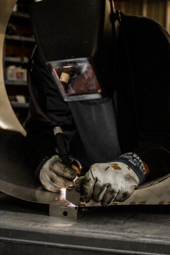 Welder Working Hard on an Air Cleaning Blower